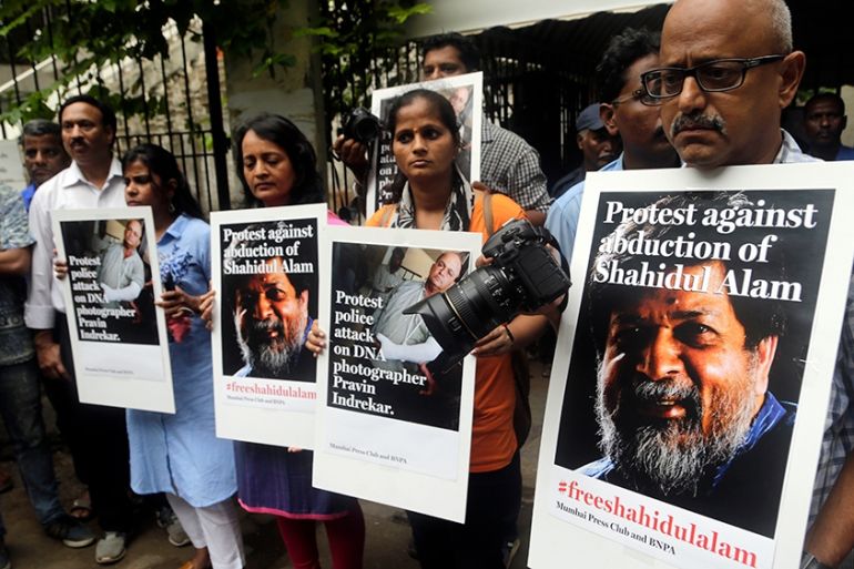 Indian journalists hold placards protesting against the attack on journalists and the arrest of Shahidul Alam, a renowned photographer and Bangladeshi activist as they gather outside Press Club in Mum