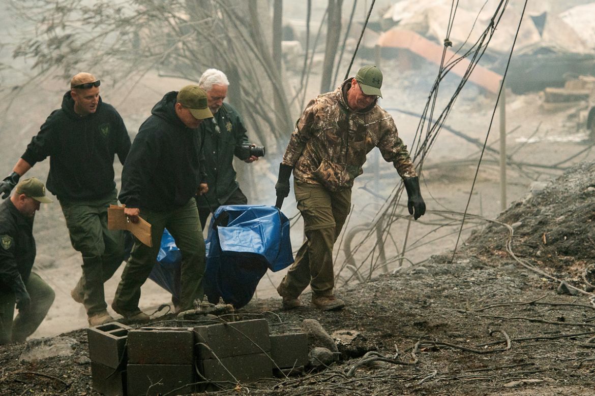 Sheriff''s deputies carry the remains of a victim of the Camp Fire on Saturday, Nov. 10, 2018, in Paradise, Calif. (AP Photo/Noah Berger)