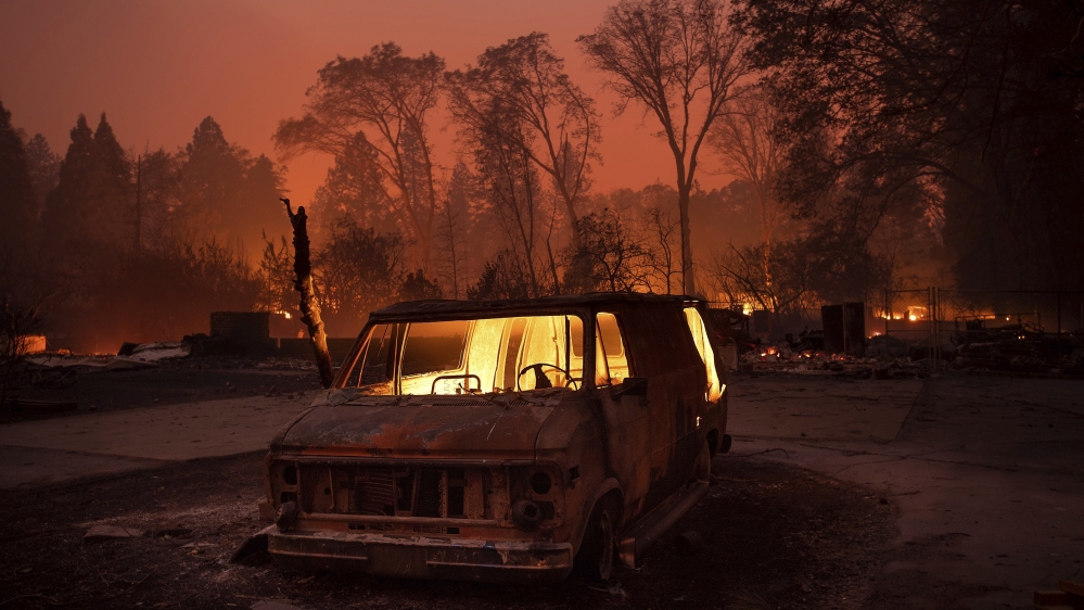 Flames burn inside a van as the Camp Fire tears through Paradise, California [Noah Berger/AP Photo]