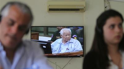 Former Khmer Rouge head of state Khieu Samphan on screen in the media centre at the Khmer Rouge Tribunal [Pring Samrang/Reuters] 