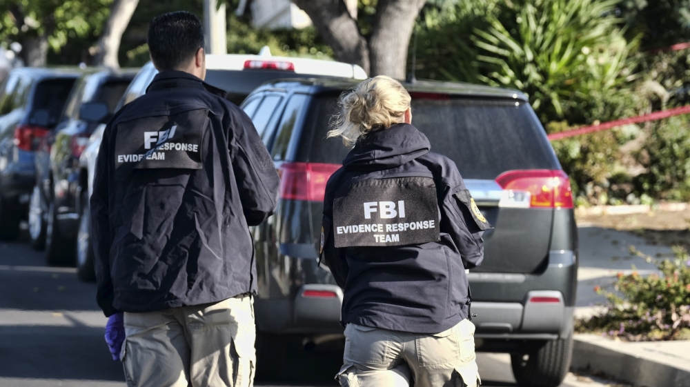 FBI investigators arrive outside the house of shooting suspect David Ian Long in Newbury Park, California [Richard Vogel/AP Photo]