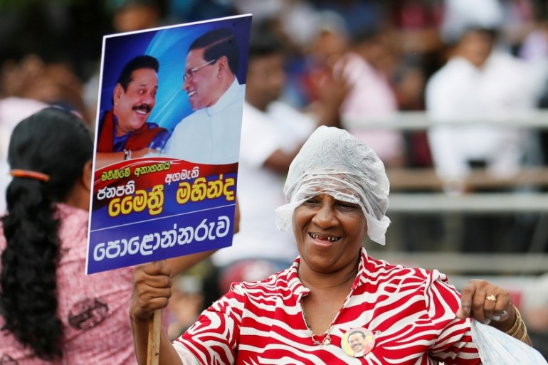 A supporter celebrates during the Sri Lanka''s newly appointed Prime Minister Rajapaksa and President Sirisena''s rally