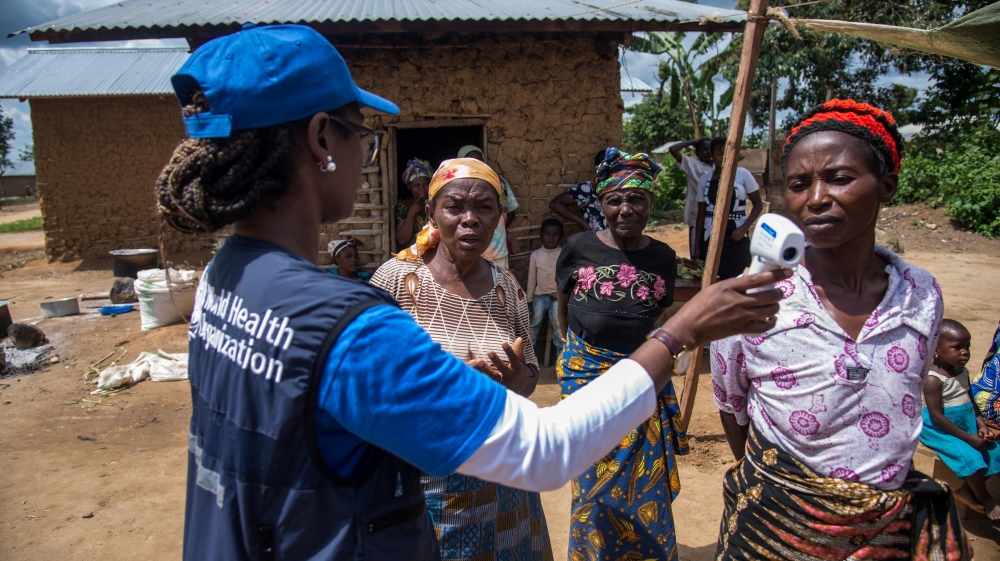 A WHO official talks to local women in DR Congo as part of the effort to fight Ebola [Reuters]