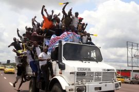 Supporters of Congolese opposition presidential candidate Martin Fayulu chant slogans while riding on a truck as they welcome him at N''djili International Airport in Kinshasa