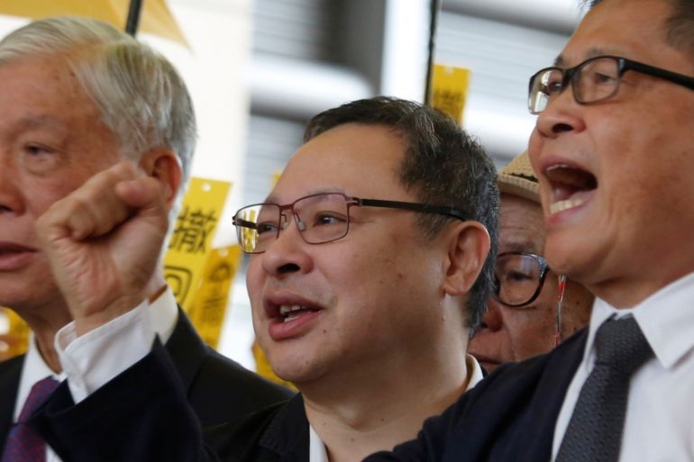 Occupy Central pro-democracy movement founders Chu Yiu-ming, Benny Tai and Chan Kin-man chant slogans in Hong Kong