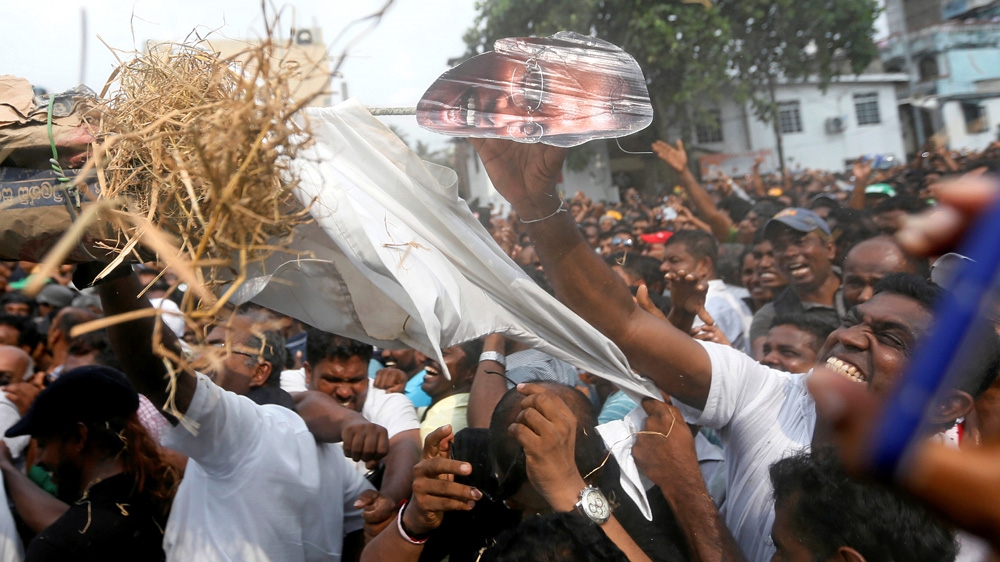 Sirisena's critics have staged daily protests since he dismissed Wickremesinghe [Dinuka Liyanawatte/Reuters]
