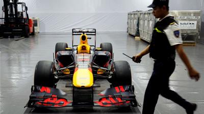 A security guard walks past the Red Bull team's Formula One car during an event in Hanoi this week [Nguyen Huy Kham/Reuters]