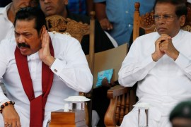 Sri Lanka''s newly appointed Prime Minister Rajapaksa reacts next to President Sirisena during a rally near the parliament in Colombo