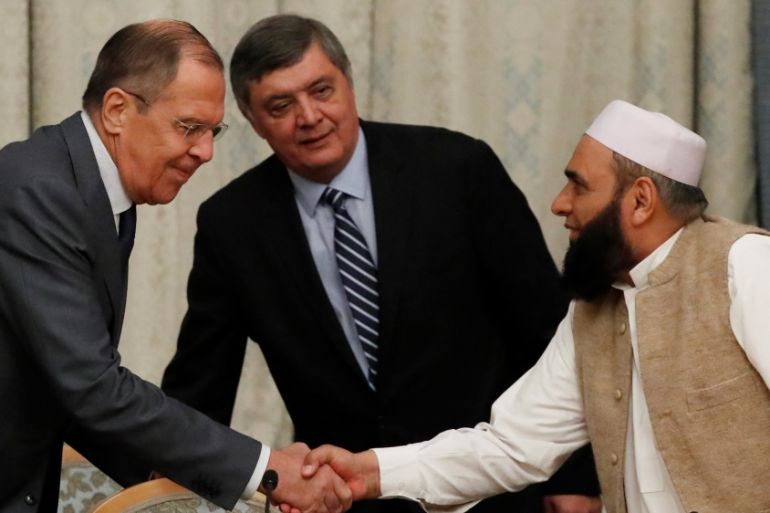 Russian Foreign Minister Lavrov welcomes member of Taliban delegation Shaina during the multilateral peace talks on Afghanistan in Moscow