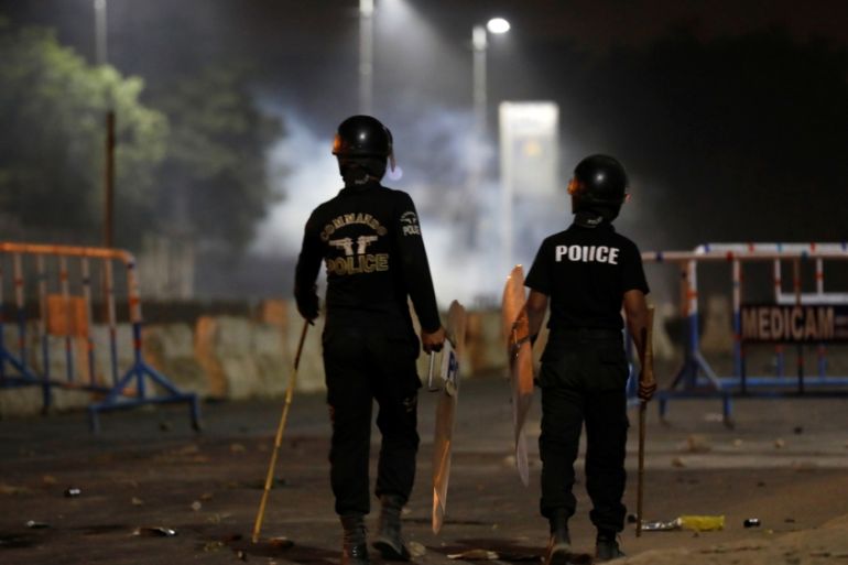 Police officers stand guard during a protest, after dispersing the supporters of the Tehrik-e-Labaik Pakistan Islamist political party, in Karachi