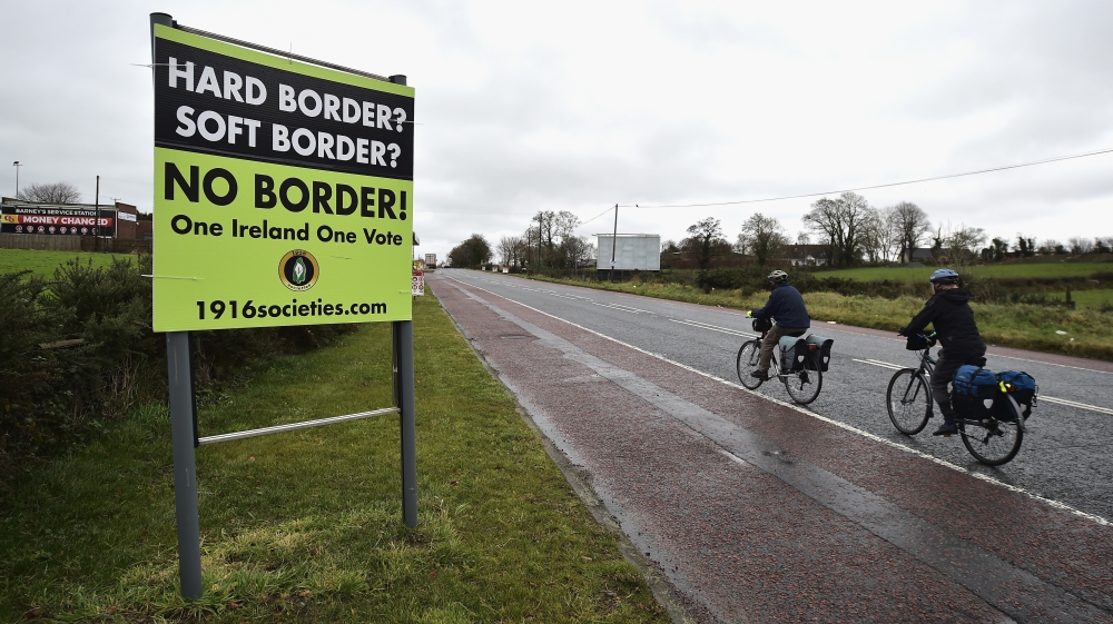 Cyclists ride past a No Border sign on November 14, 2018 in Ravenscourt, Northern Ireland [Charles McQuillan/Getty Images]