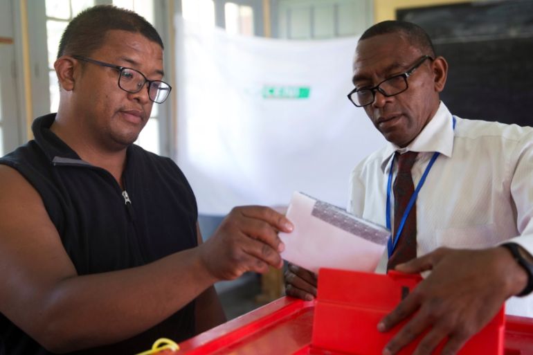 An electoral commission official looks on as a voter casts his ballot during the presidential election at a polling centre in Analakely, Antananarivo, Madagascar November 7, 2018