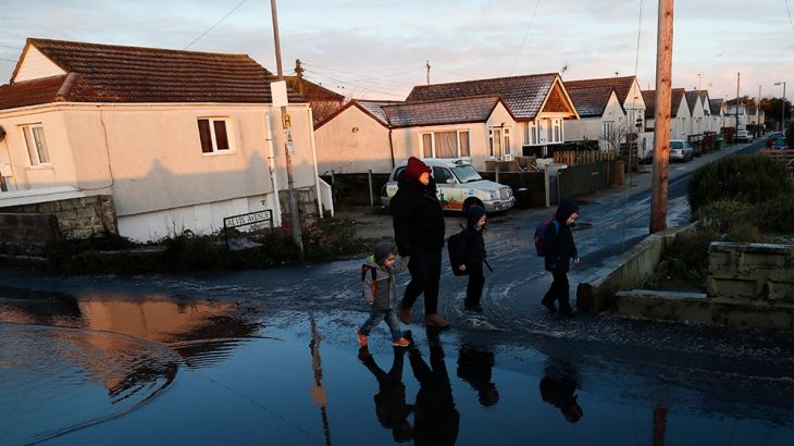 Residents walk through the village of Jaywick which is threatened by a storm surge, in Essex, Britain January 13, 2017. [File: Stefan Wermuth/Reuters]
