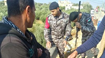 Jordanian civil defence officers searching for survivors in Mlaih [Al Jazeera]