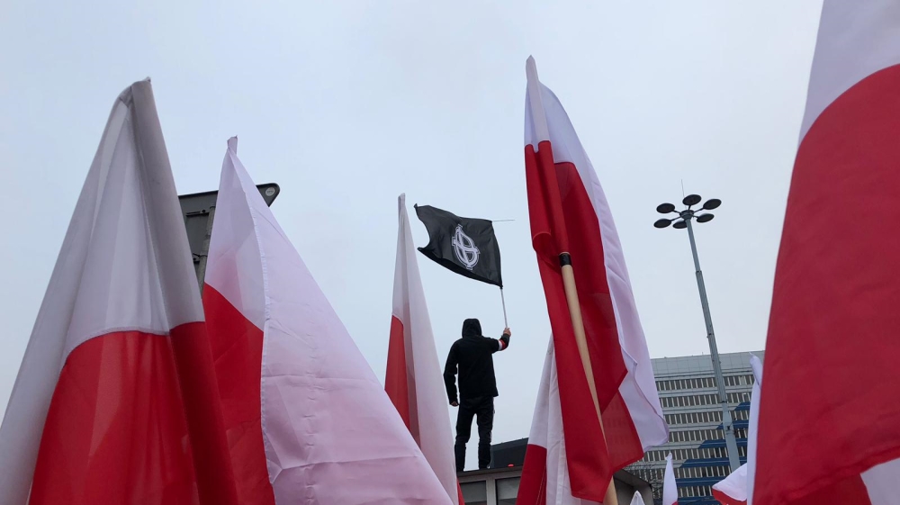 



One man raised a flag bearing the Celtic Cross, which is used as a hate symbol by neo-Nazis [Agnieszka Pikulicka-Wilczewska/Al Jazeera]



One man raised a flag bearing the Celtic Cross, which is used as a hate symbol by neo-Nazis [Agnieszka Pikulicka-Wilczewska/Al Jazeera]