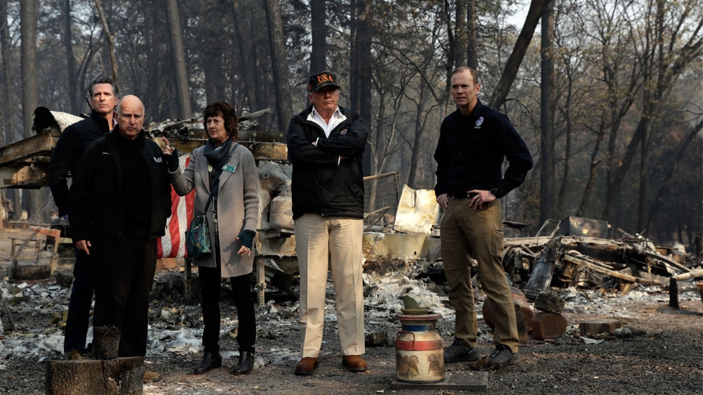 Trump tours a neighbourhood destroyed by the wildfires in Paradise, California [Evan Vucci/AP]