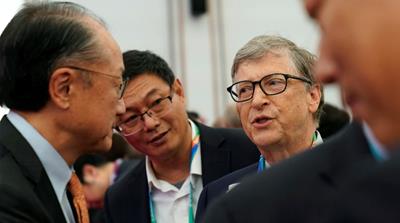Microsoft founder Bill Gates with World Bank President Jim Yong Kim before the opening ceremony at the Shanghai expo [Aly Song/Reuters]