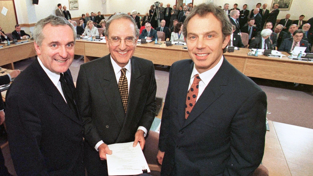 Then-UK Prime Minister Tony Blair, US Senator George Mitchell and Irish Bertie Ahern pose together after signing the Good Friday Agreement in 1998 [File: The Associated Press]