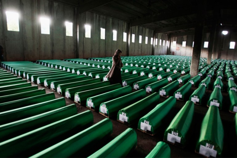 A Bosnian Muslim woman searches coffins in Potocari, near Srebrenica July 9, 2011. The bodies of the 614 recently identified victims of Srebrenica massacre will be buried on July 11,