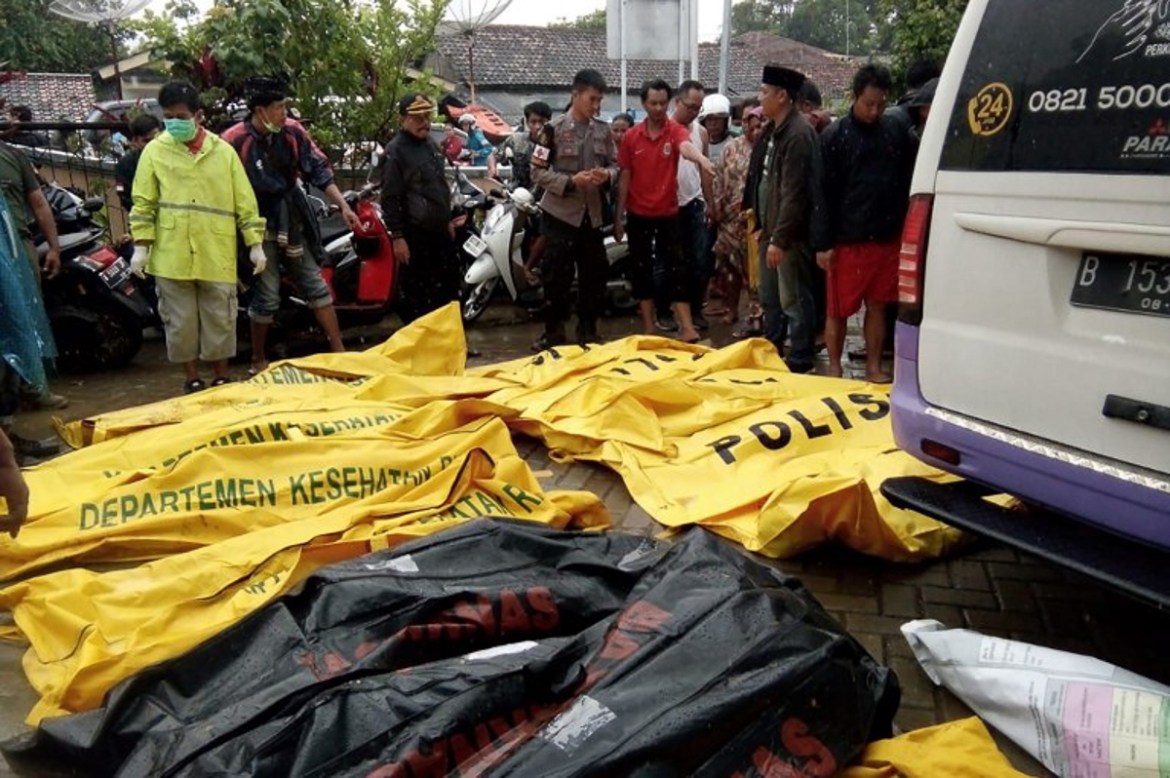 Bodies of victims recovered along Carita beach are placed in body bags on December 23, 2018, after the area was hit by a tsunami on December 22 following an eruption of the Anak Krakatoa volcano. - A