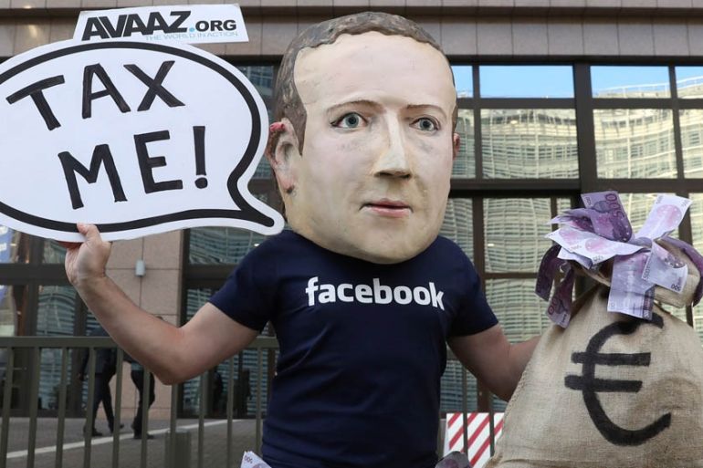 Activist wearing a mask depicting Facebook''s CEO Mark Zuckerberg