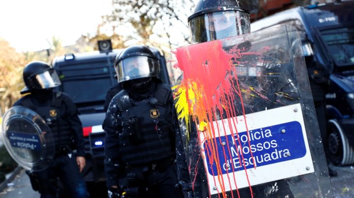 A police officer holds up a shield during a protest against Spain''s cabinet meeting in Barcelona