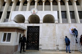A security guard stands in front of the United Arab Emirates embassy in Damascus during its reopening