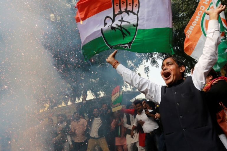 Supporters of India''s main opposition Congress party celebrate after initial poll results at the party headquarters in New Delhi