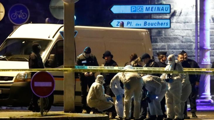 Investigators work on the street during a police operation in the Meinau in Strasbourg