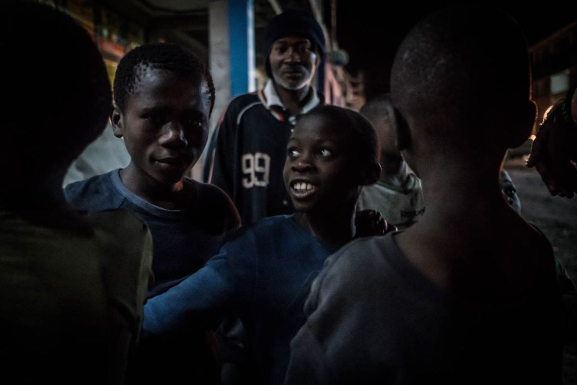 A group of street children on Goma’s Kanyamuhanga Boulevard. The main is road lined with colourful bars with bright flashing neon lights and booming music out of big speakers. At night the city can be