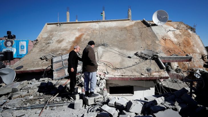 People look at the house of Palestinian family Abu Humaid after it was blown up by the Israeli forces in al-Amari refugee camp in Ramallah, in the Israeli-occupied West Bank