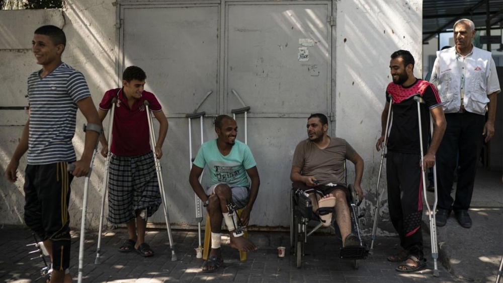 Patients with leg injuries they attained during demonstrations, gather outside a clinic run by MSF  in Gaza City in September 2018 [Associated Press]