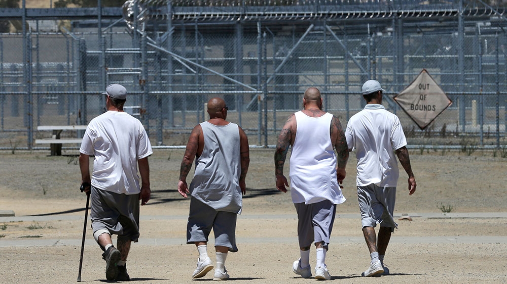 Inmates walk the exercise yard at the California Medical Facility in Vacaville, California [Rich Pedroncelli/AP Photo] 