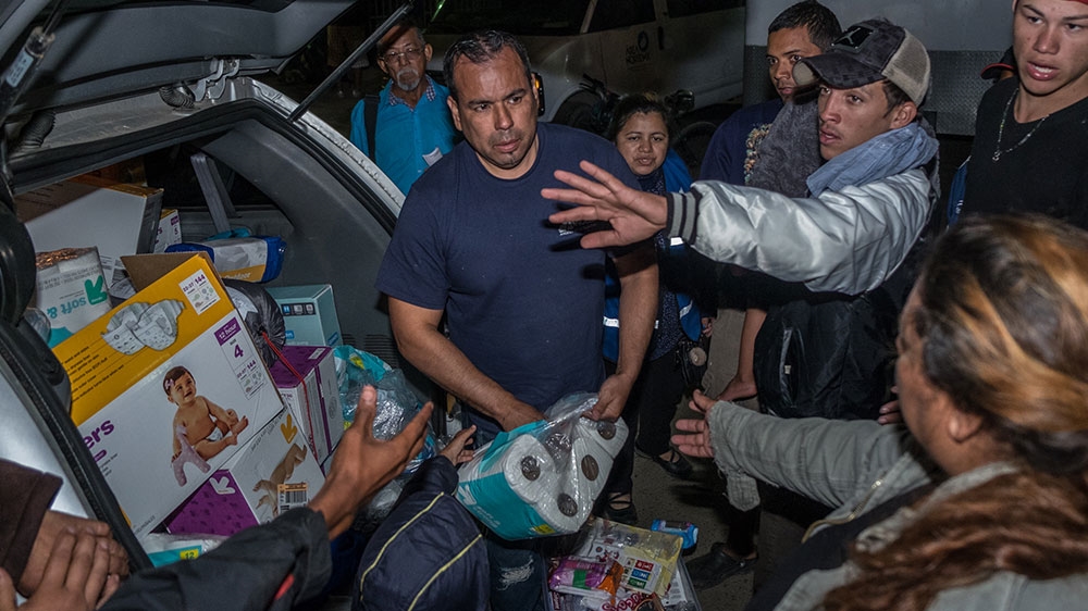 Castro hands out donations in Tijuana [Eline van Nes/Al Jazeera]