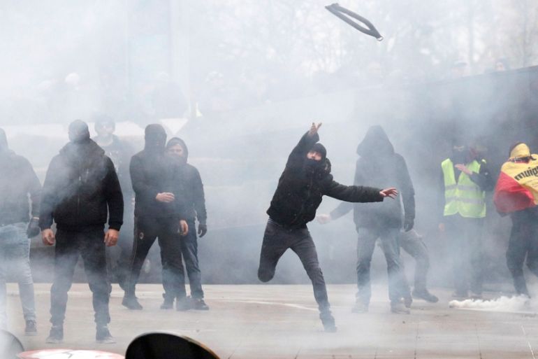 Far-right supporter throws an object during a protest against Marrakesh Migration Pact in Brussels