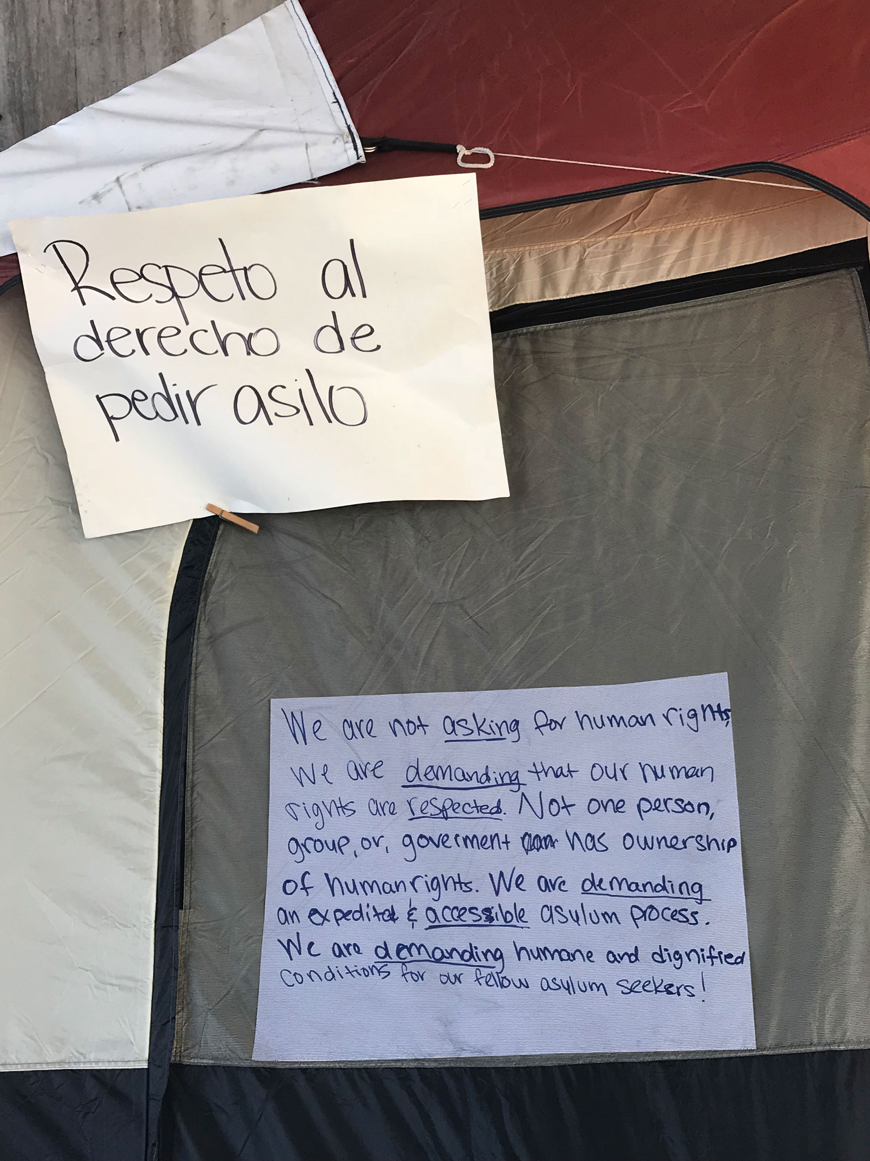 A sign on a tent of the hunger strikers' encampment reads, 'Respect the right to ask for asylum' [Nidia Bautista/Al Jazeera]