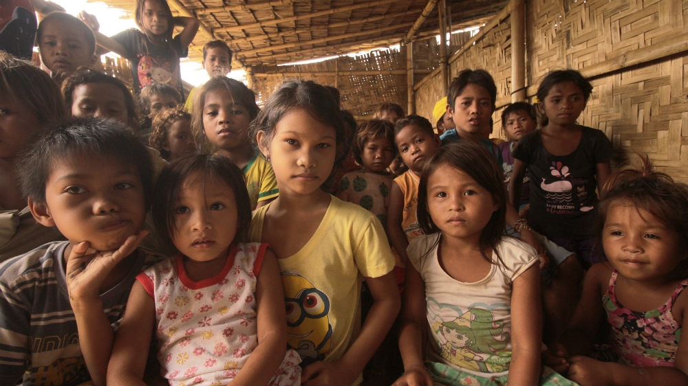 Lumad students of different ages are often taught together in a single classroom by one teacher because of the problems caused by the continuing instability in Mindanao [Jose Hernani/Al Jazeera]