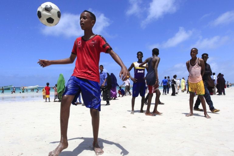 Somali boys play football in Lido beach while celebrating the Muslim Eid al-Fitr holiday, which marks the end of the fasting month of Ramadan, in capital Mogadishu