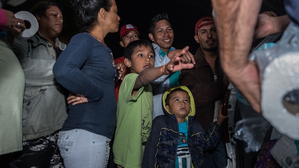 Children and others ask for specific items as Castro hands out donations in Tijuana [Eline van Nes/Al Jazeera] 