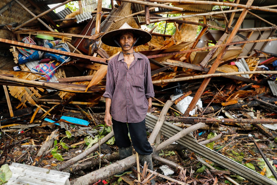 A man stands in front of his destroyed house, after it was hit by a tsunami in Pandeglang, Banten province, Indonesia, December 24, 2018. REUTERS/Jorge Silva