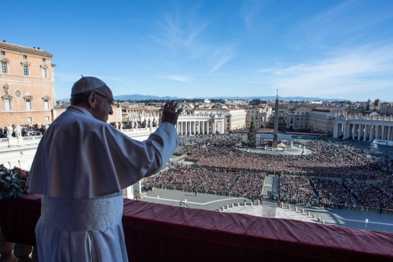 Pope Francis waves as he arrives to deliver the "Urbi et Orbi" message from the main balcony of Saint Peter''s Basilica at the Vatican