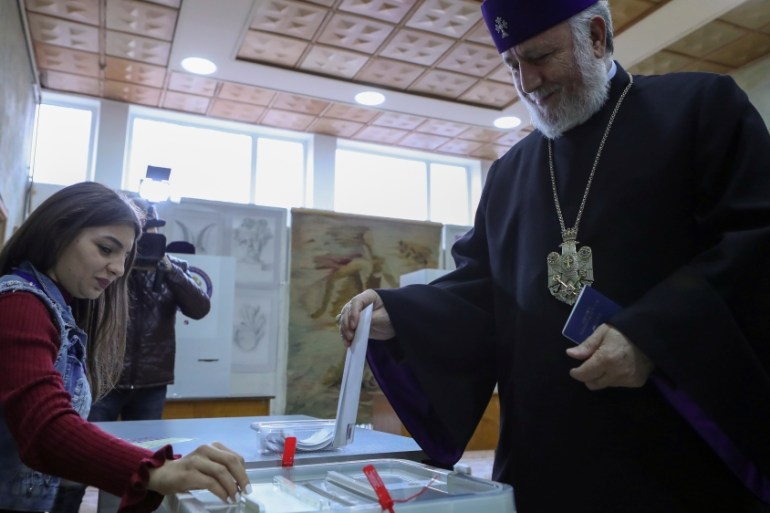 Catholicos of All Armenians Karekin II casts his ballot during an early parliamentary election in the town of Vagharshapat