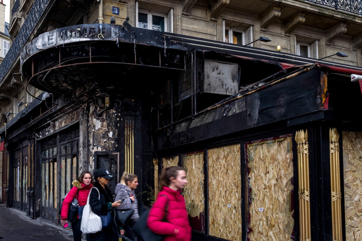 A group of young women walks in front of a restaurant that was burned during last Saturdayi´s protests on December 03, 2018 in Paris, France. While the final cost of the destruction is still to be det
