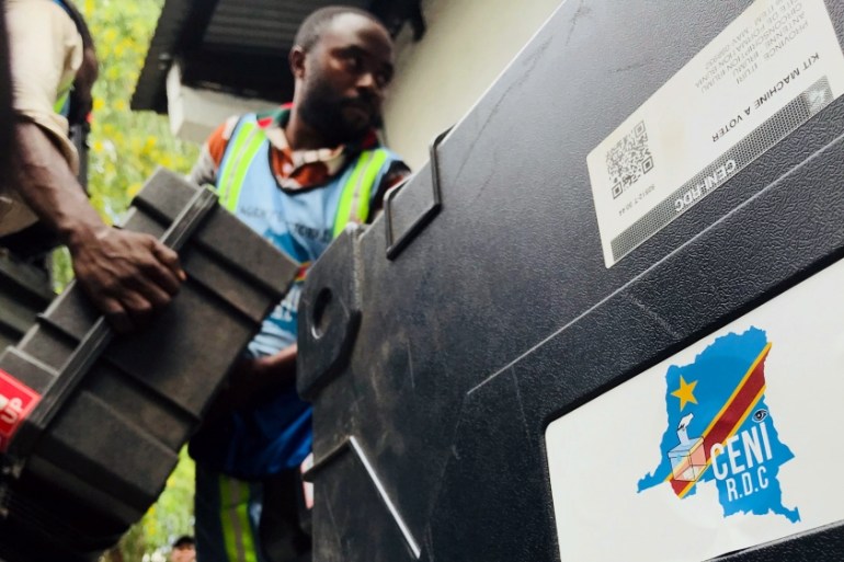 Employees of Congo''s Independent National Electoral Commission (CENI) deliver voting machines and materials to a polling station in Kinshasa