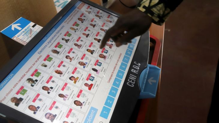 A worker of Congo''s National Independent Electoral Commission (CENI), tests a voting machine ahead of the postponed presidential election, at the CENI offices in Kinshasa