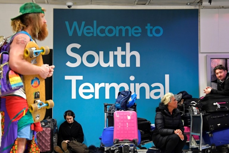 Passengers wait in the South Terminal building at Gatwick Airport