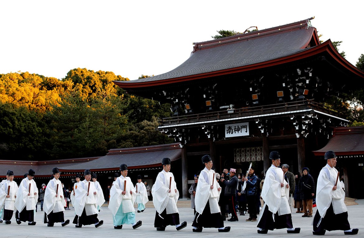 Shinto priests walk to attend a ritual to usher in the upcoming New Year at Meiji Shrine in Tokyo, Japan December 31, 2018. REUTERS/Kim Kyung-Hoon