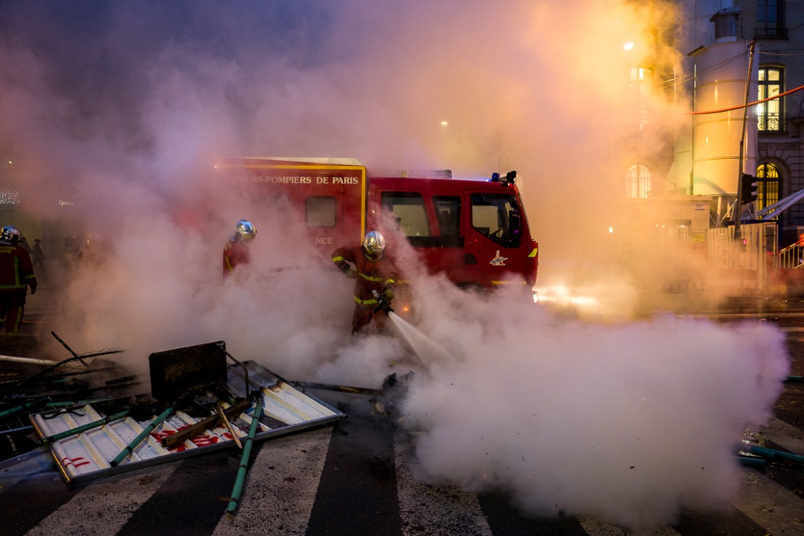 Members of the fire department put out a fire set up on fire by extremists vandals infiltrated during a protest called for by the i`Gilets Jaunesi^ movement December 01, 2018 in Paris, France. Photo