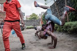 Key B (23), DMD (22), and Diem Key (17) - members of the Hip-Hop collective Shusha Ma Flow - are practising their dance moves during a break in the recording studio in Goma.