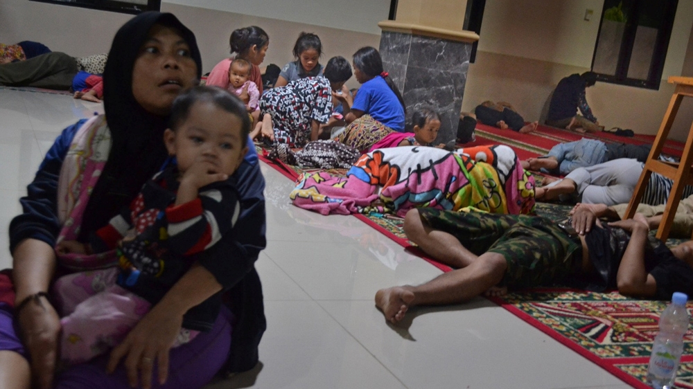 Residents sit inside a mosque as they evacuated following high waves and the eruption of Anak Krakatau volcano at Labuan district in Pandeglang regency [Muhammad Bagus Khoirunas/Reuters]